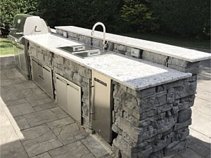 Nicolock Belvedere Stone Precast BBQ BAR sink weber white counter top dual level bar Gray grey stone custom fridge storage doors